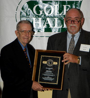 Paul Savage (right) presenting Mal Elliott (left) with his Hall of Fame plaque