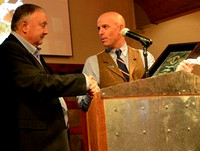 Ross Randall (left) receives a plaque from